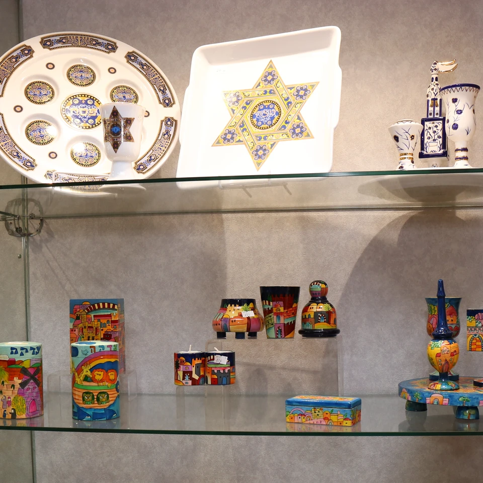 Colourful Judaica pieces on glass shelves